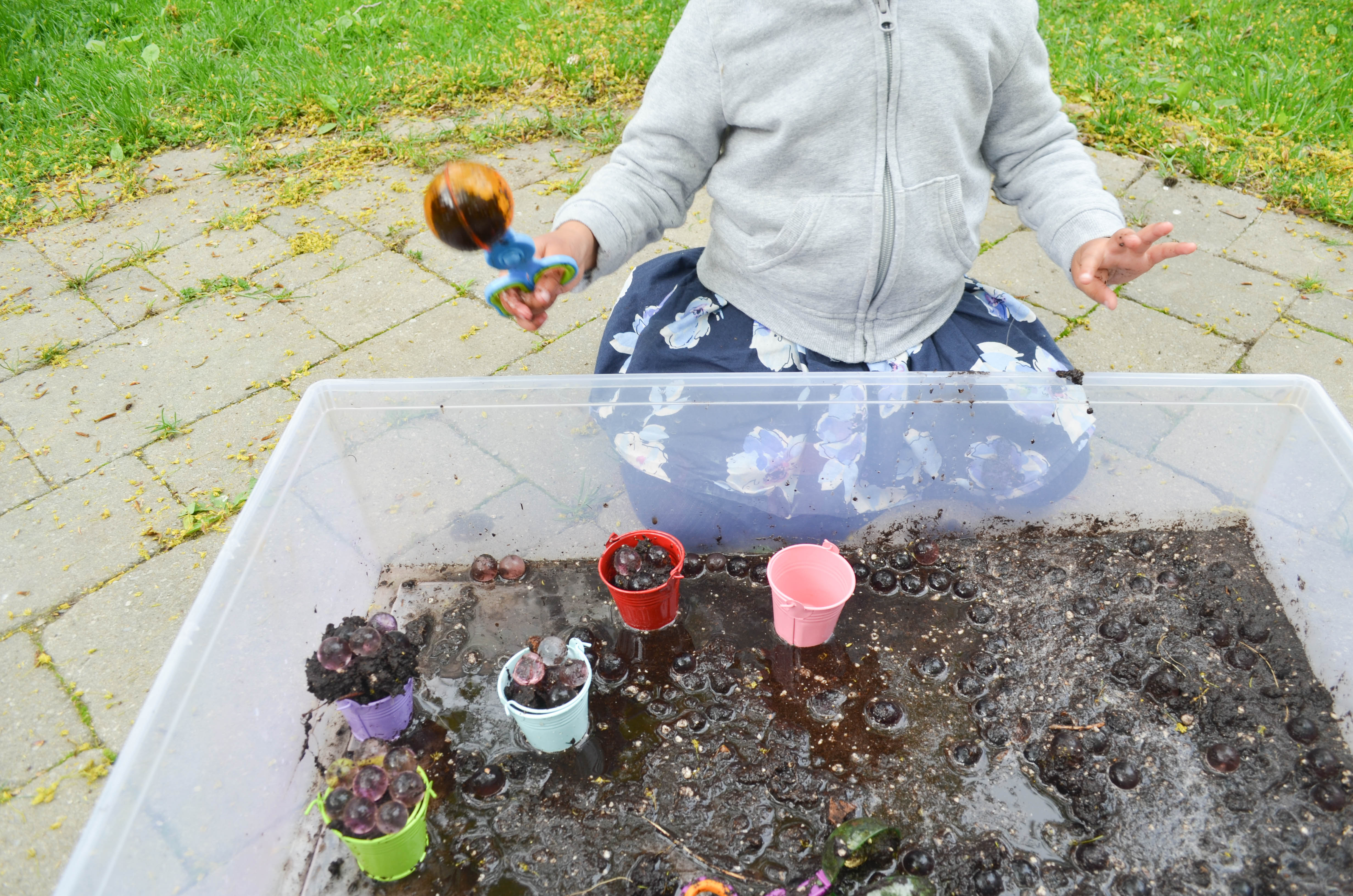 Water beads in mud sensory bin for toddlers