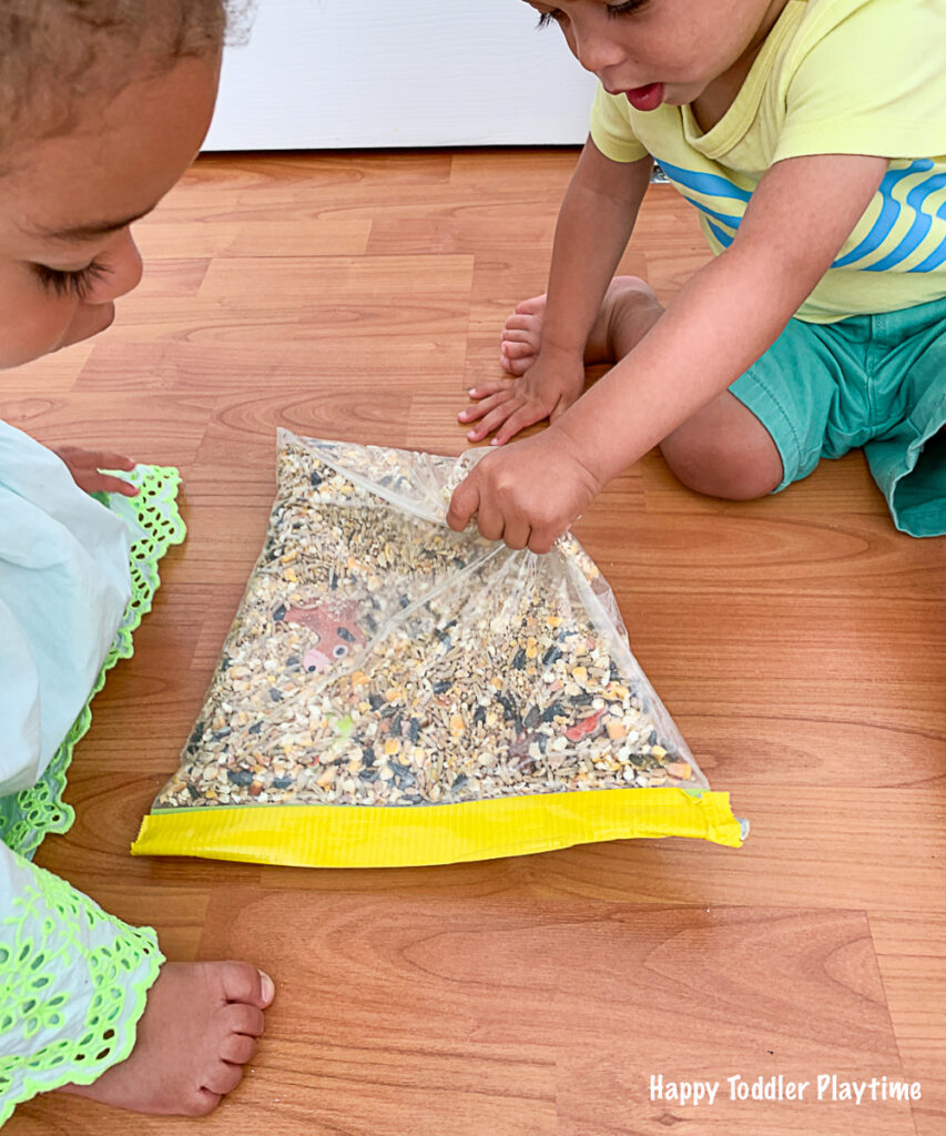 Toddlers playing with a farm sensory and discovery bag