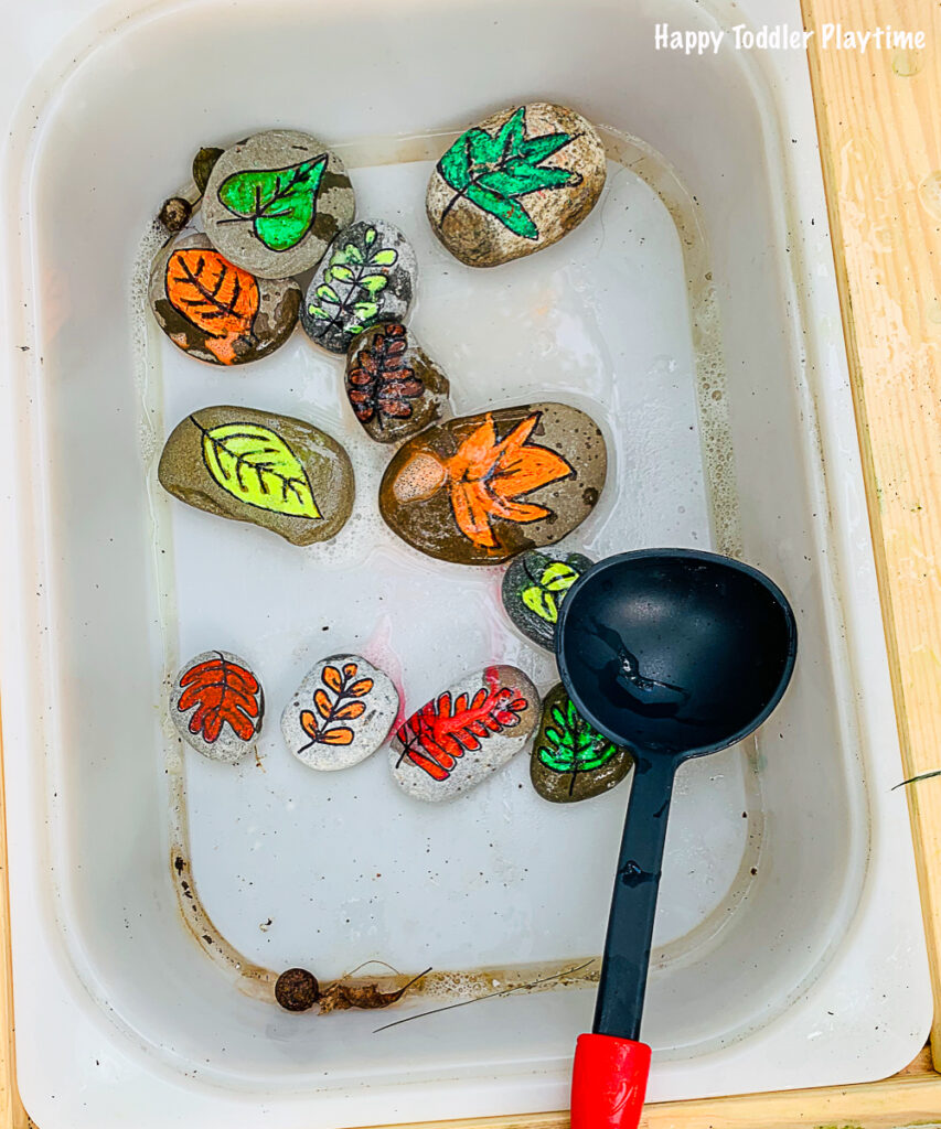 A toddler activity using DIY leaf rocks in water