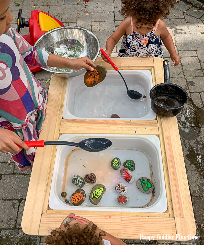A toddler activity using DIY leaf rocks in water